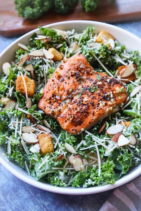 white bowl with kale salad topped with juicy pan fried salmon, parmesan, almonds, and croutons Salmon Kale Salad, Salmon Kale, Salad With Salmon, Best Salmon, Kale Caesar, Kale Caesar Salad, Pan Fried Salmon, Kale Salad Recipes, Caesar Salad Recipe