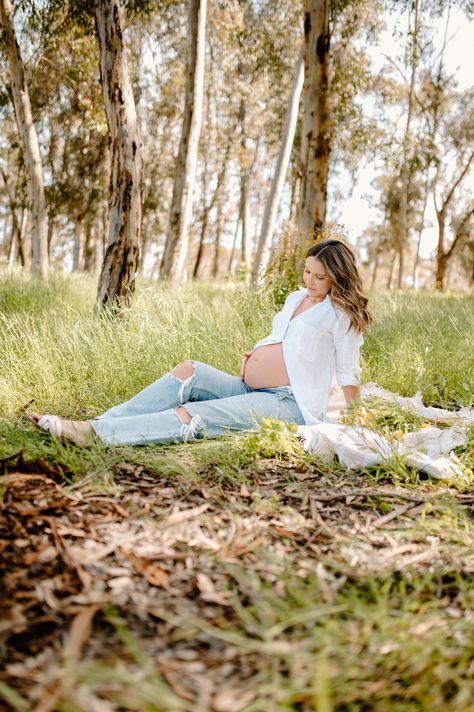 Mama poses in Eucalyptus trees with a white button up and jeans while showing off her cute baby bump Maternity Pictures White Button Up, Open Jeans Maternity Photos, Maternity Pictures Jeans White Shirt, Maternity Photo Shoot White Button Up, Maternity Photography Poses Mom Only, Maternity Pics Jeans, Maternity Pics With Jeans, Maternity Photography With Jeans, Blue Jean Maternity Pictures Photo Ideas