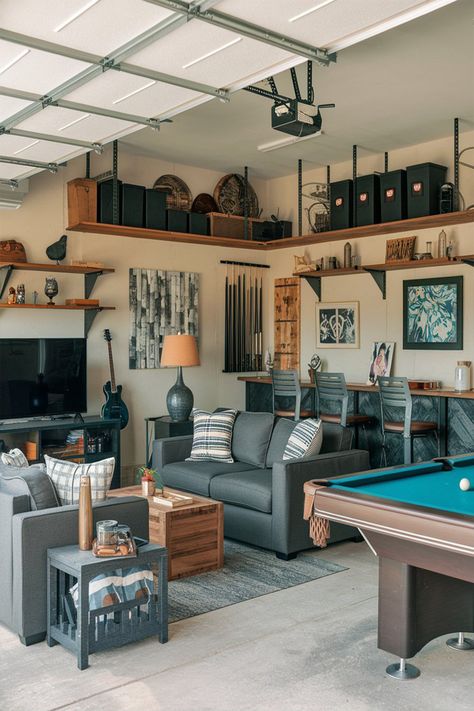 A photo of a garage turned man cave with various items. There's a sofa, a coffee table, a TV, a bar with a few chairs, and a pool table. There are also shelves with decorative items, a guitar, and a lamp. The walls have a few pieces of artwork and a few storage units. The floor is covered with a rug. Less Man Cave Sitting Area, Man Cave Garage Wall Shelves, Pool Table Garage, Small Garage Hangout Ideas, Garage With Pool Table, Garage Pool Table Room, Garage Pool Table, Basement Pool Table Room Ideas, Garage Hang Out Space