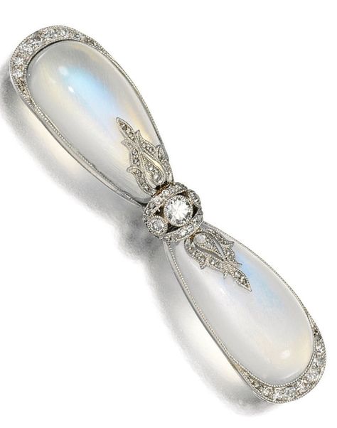 A Belle Epoque moonstone and diamond brooch, Cartier, circa 1905. Designed as a bow set with two pear-shaped cabochon moonstones accented with circular-cut and rose diamonds, signed Cartier Paris and numbered, French assay marks. #Cartier #BelleÉpoque #brooch Diamond Brooch Cartier, Moonstone Brooch, Nouveau Jewelry, Art Nouveau Jewelry, Diamond Brooch, Bow Set, Gemstone Jewellery, Moonstone Jewelry, Old Jewelry