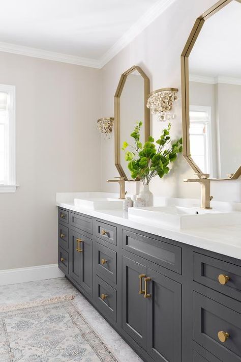 Glass droplets sconces flank a gold mirror over a black bath vanity accented with brass hardware and a brass faucet fixed above an overmount sink. Makeover Kamar Mandi, Vanity Ideas, Entrance Foyer, Master Bath Remodel, Foyer Design, Bathroom Remodel Shower, Lodge Decor, Upstairs Bathrooms, Grey Bathrooms