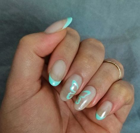 25 Taylor Swift Nail Ideas - Lauren Erro Taylor Swift Nails Inspired Eras Tour French Tip, Taylor Swift Debut Inspired Nails, Teal Butterfly Nails, Debut Nails Taylor Swift, Blue Butterfly Nail Designs, Taylor Swift Debut Nails, French Tips With Butterfly, Summer Europe Nails, Butterfly French Tip Nails