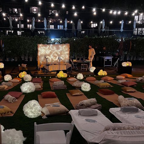 An outdoor evening concert with a bed as a stage and a keyboard on the side, surrounded by yoga mats, blankets, pillows and handmade lanterns that look like clouds. Yoga Event Ideas, Faux Clouds, Rest Ideas, Yoga Event, Lullaby Club, Night Yoga, Diy Lantern, College Event, Music Meditation