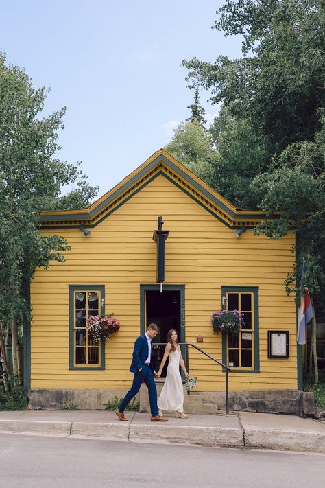 A bride and groom walk in front of an old, yellow, western-style building in Breckenridge, Colorado during their elopement. Colorado Courthouse Wedding, Breckenridge Elopement, Elopement Courthouse, Western Elopement, Birch Wedding, Courthouse Elopement, Breckenridge Wedding, Elopement Colorado, Wedding Colorado