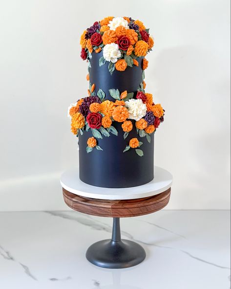 Buttercream florals on an all black cake to celebrate autumn’s colors 🖤🌹🧡 Mexican Inspired Cake, Marigold Cake, Dark Floral Wedding Cake, Marigold Wedding Cake, Dia De Los Muertos Wedding Ideas, Mexican Cake Ideas, Dia De Los Muertos Cake Ideas, Moody Floral Wedding Cake, Glamorous Wedding Cakes