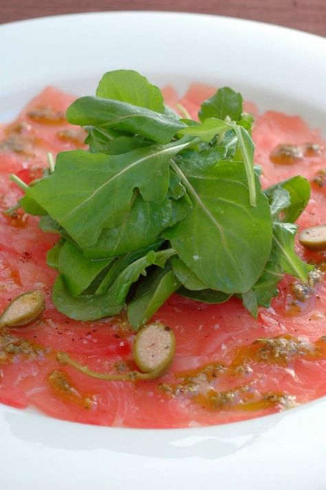 Tuna Carpaccio with Basil Oil Lemon and Caper Berries Italian Sushi, Appetizer Night, Tuna Carpaccio, Mediterranean Theme, Carpaccio Recipe, Caper Berries, Sushi Ingredients, Tuna Fillet, Raw Tuna