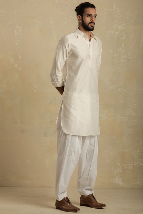 Featuring a pearl white pathani kurta in chanderi base with mirror embroidery. It is paired with matching cotton salwar pants.  FIT: True to size. COMPOSITION: Chanderi, Cotton. CARE: Dry clean only. White Kurta Men, Pathani For Men, Pathani Kurta, Salwar Pants, Gents Kurta Design, Gents Kurta, Mirror Embroidery, Kurta Men, Kurta Set For Men