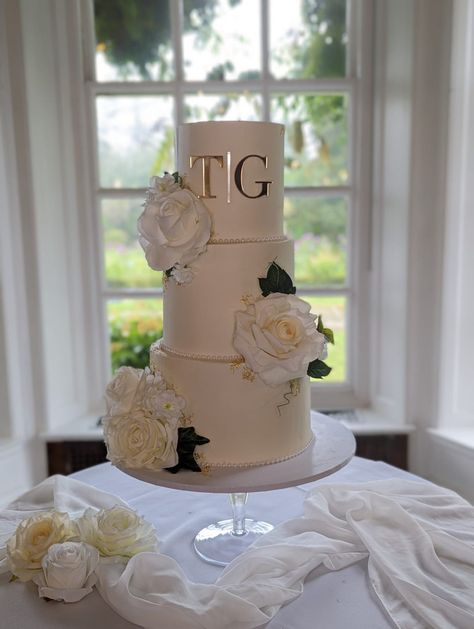 3 tier wedding cake Elegant & glamerous finish with gold initials and white blooms Www.babycakesguildford.co.uk Three Tier Buttercream Wedding Cake, Initials On Wedding Cake, 3 Tier Wedding Cake Elegant, White Floral Wedding Cake, Wedding Cake Two Tier, 3 Tier Wedding Cake, 4 Tier Wedding Cake, Cake Elegant, White Floral Wedding