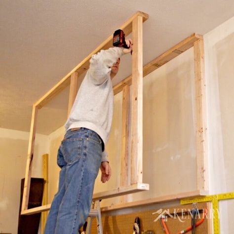 DIY Garage Storage: Great idea for ceiling mounted shelves in the garage for better seasonal storage! Hang Shelves From Ceiling, Garage Hanging Shelves, Garage Storage Ideas Ceiling, Ceiling Garage Storage, Ceiling Mounted Shelves, Garage Storage Ceiling, Storage Ceiling, Diy Garage Storage Ideas, Seasonal Storage