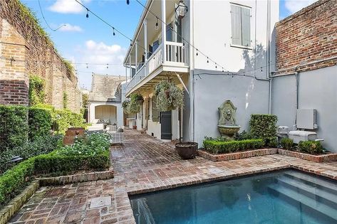 1118 Burgundy St, New Orleans, LA 70116 | MLS #2450572 | Zillow Courtyard With Pool, New Orleans Courtyard, Creole Cottage, Brick Cottage, Courtyard Pool, Elegant Bedding, Charter School, Two Story Homes, Saltwater Pool