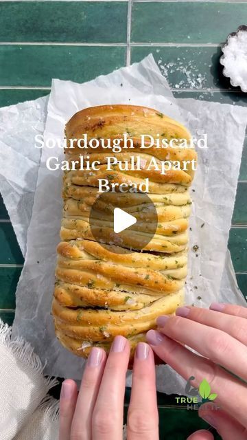 True Heath Experts on Instagram: "🍞🧄 Sourdough Garlic Pull-Apart Bread 🧄🍞

Indulge in the savory goodness of Sourdough Garlic Pull-Apart Bread! 🌟

Why you’ll love it:

* Flavor-Packed: Infused with rich garlic and butter for a mouthwatering treat.
* Perfect for Sharing: Ideal for gatherings or a cozy night in.
* Healthy Twist: Made with wholesome sourdough, offering better digestion and nutrients.
* Easy & Fun: Simple to make and fun to pull apart and enjoy.

How to prepare:

1. Prepare Dough: Use your favorite sourdough recipe or pre-made dough.
2. Make Garlic Butter: Mix melted butter with minced garlic and fresh herbs.
3. Shape & Slice: Roll out the dough, spread the garlic butter, and cut into squares.
4. Layer & Bake: Stack the squares in a loaf pan and bake until golden brown.
5 Make Garlic Butter, Sourdough Recipe, Discard Recipes, Bread Bakery, Better Digestion, Healthy Swaps, Sourdough Discard, Pull Apart Bread, Nutritious Snacks