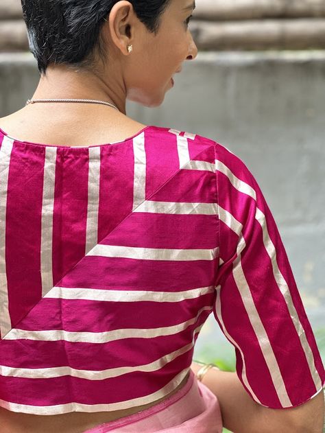 In line with our dedication to producing unique, versatile blouses with meticulous attention to detail, is this bright pink mashru silk blouse with silver stripes that is tailored to perfection. Designed for year-round comfort, this blouse has a high back to flaunt those perfect angles and a low back with front open. Front Open Blouse Designs, Stripes Blouse Designs, Back Open Blouse Designs, Striped Blouse Designs, Stripes Blouse, Latest Blouses, Open Blouse, Latest Blouse Designs Pattern, Indian Saree Blouse