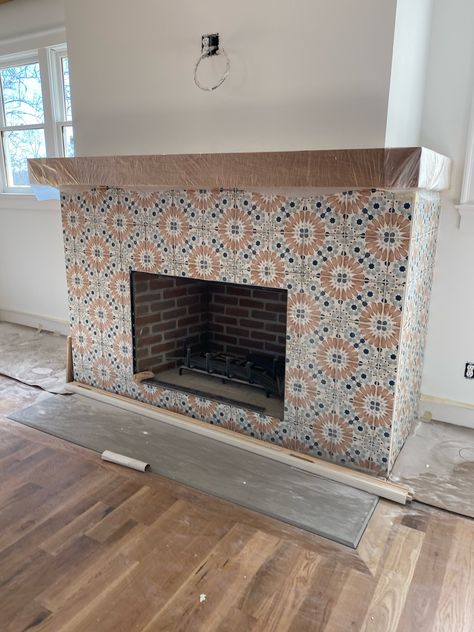 Encaustic Tile Fireplace, Fireplace Moroccan Tile, Mexican Tile Fireplace Ideas, Cool Fireplace Tile, Spanish Tiled Fireplace, Stenciled Fireplace Surround, Fun Fireplace Tile, Fireplace With Spanish Tile, Chairs On Each Side Of Fireplace