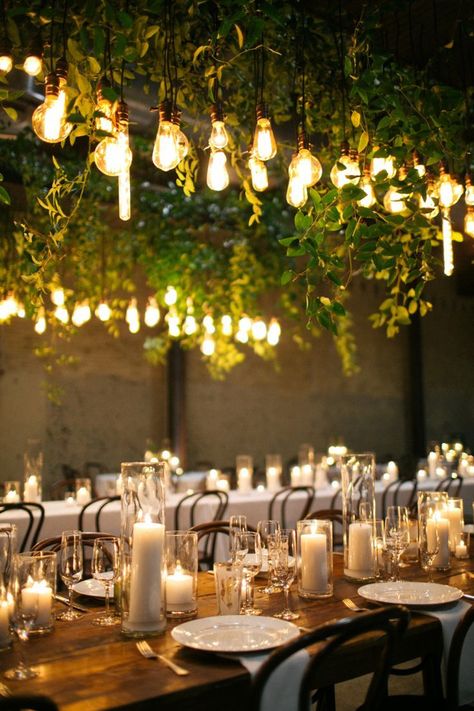 edison bulb and green vine installation over reception tables // wedding, candle centerpiece, lighting, mood, ambiance, industrial, farm table, rustic Edison Bulb Wedding, Candlelit Reception, Candles And Flowers, Wedding Reception Lighting, Ceremony Candles, Wedding Backyard Reception, Simple Wedding Decorations, Wedding Lighting, Candle Table