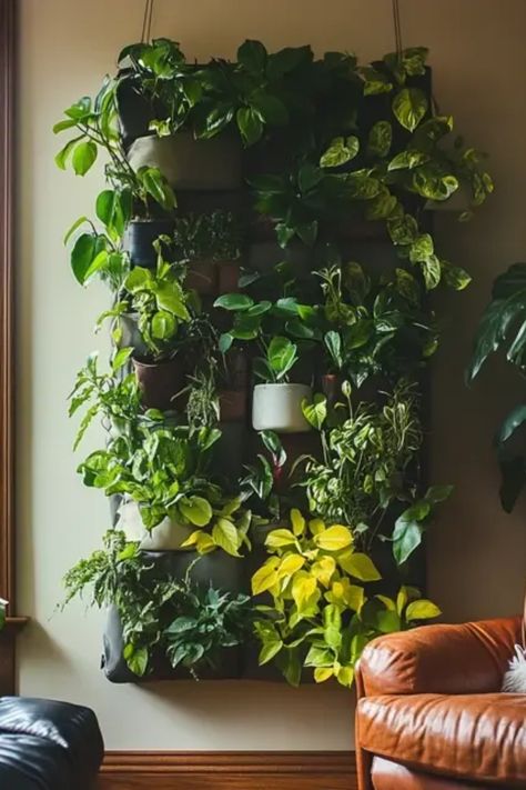 Transform your space with a stylish DIY indoor plant wall! This fun project will bring the outdoors inside and give your home a fresh vibe. Get creative using various plants such as ferns, succulents, and more. Perfect for small spaces, an indoor plant wall can dramatically enhance your decor. This guide provides tips on plant selection, positioning, and maintenance to ensure a thriving green display. Whether you're a plant lover or a home decor enthusiast, creating an beautiful indoor oasis has never been easier! Live Plant Wall Indoors Diy, Indoor Living Plant Wall, Wall Plant Display Indoor, Fake Plants Wall Decor, Creative Plant Display, Wall Hanging Planters Indoor, Diy Living Wall Art, Small Plant Wall, Indoor Greenery Wall