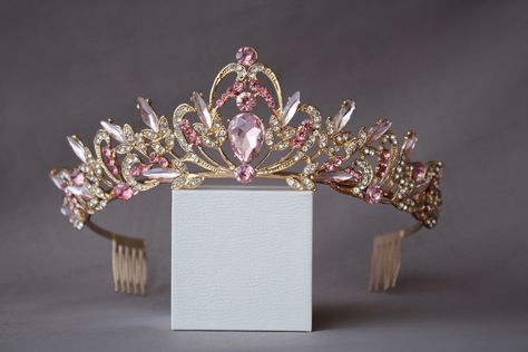 A small and delicate pink crown. The crown is perfect for both children and adults due to its small size and weight. Beautiful sparkling tiara with pink crystals in gold or silver plated. Incredible tiara that will look great on the bride. I'm sure you will get a lot of compliments.  Height of the tiara - 2"( 5 см) Features: Tiara made with pink crystals and rhinestones Sturdy metal frame Delicate crystal pattern Care instructions: Avoid contact with water Clean with a soft cloth Store in a cool Crystal Wedding Crown, Pink Tiara, Wedding Tiara Veil, Tiara Silver, Crystal Crown Wedding, Crown Birthday, Birthday Tiara, Crown Crystal, Crystal Bridal Tiaras