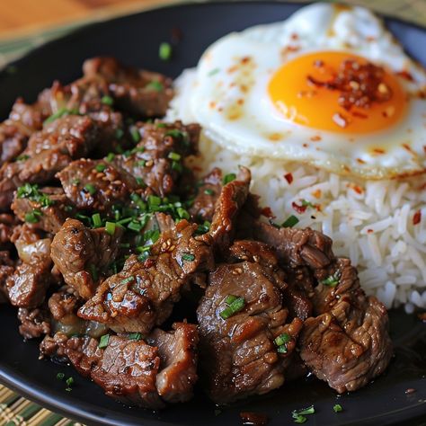 🍳 Enjoy the Filipino classic Tapsilog! 🍚✨ #Tapsilog #FilipinoFood Tapsilog (Marinated Beef, Garlic Rice, and Fried Egg) Ingredients: Beef sirloin, thinly sliced (1 lb) Soy sauce (1/4 cup) Vinegar (2 tbsp) Garlic, minced (4 cloves) Brown sugar (1 tbsp) Cooked rice (2 cups) Garlic, minced (2 cloves) Eggs (2) Vegetable oil (for frying) Salt and pepper (to taste) Instructions: Marinate beef in soy sauce, vinegar, garlic, and brown sugar for at least 30 minutes. Fry marinated beef in a skillet... Beef Aesthetic Food, Tapsilog Aesthetic, Cosy Meals, Pinoy Ulam, Tapsilog, Beef Tapa, Garlic Rice, Filipino Cuisine, Instagram Recipes