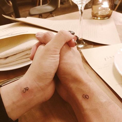 Matching wife and husband initial tattoos inked on wrists Modern Initial Tattoo, Husband And Wife Tattoos Small, Couple Finger Tattoos, Husband Wife Tattoos, Wife Tattoos, Initial Tattoos, Finger Tattoos For Couples, Husband Tattoo, Wife Tattoo