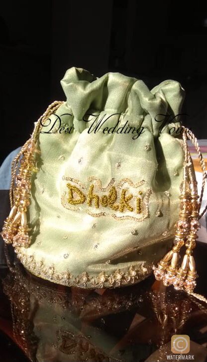 Pakistani, Indian, South Asian Bridal Pouch with the words “Dholki” embriodered on it. Bridal Pouches Pakistani, Bridal Pouch, Lolly Bags, Wedding Reception Design, Potli Bag, Unique Wedding Photos, Reception Design, Potli Bags, Asian Bridal