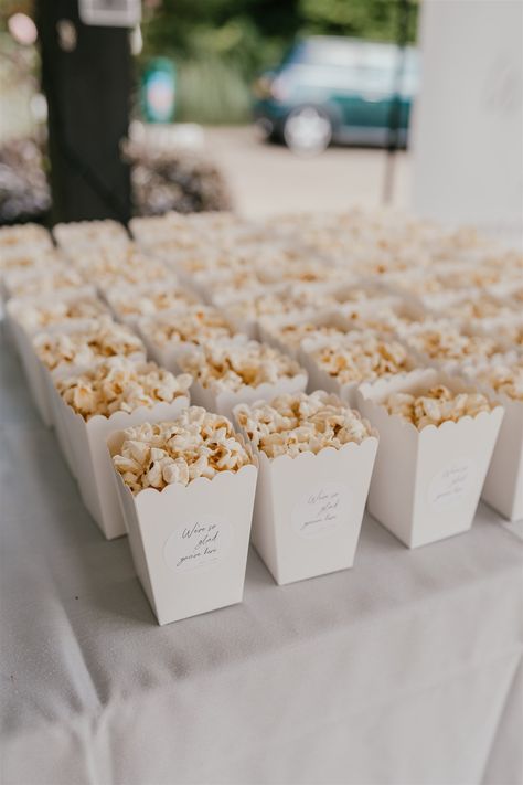 It was all about the details for Issy + Tom's August super stylish wedding at Hayne House in Hythe! No detail was left unconsidered - they used photos of their parents on their wedding days as decor, polaroids of the couple were everywhere and the bride even designed and made a wedding newspaper all about the couple which was placed on tables for guests to enjoy. Captured by natural, heartfelt wedding photographer Shelby Ellis Photography. Wedding Favor Snacks, Birthday Party Movie Night, Party Movie Night, Popcorn Cups, حفل توديع العزوبية, Popcorn Wedding, Snack Station, Wedding Snacks, White Popcorn