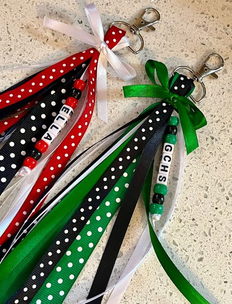 Each item includes 15-20 Ribbons Ribbons hang about 6-7 inches on both sides from a sturdy 1 inch Silver Swivel Clasp keychain.  Made in colors requested in a variety of ribbons that I have available. They are each topped with a bow in a matching color..  Ribbon pattern and designing may differ in EACH bag tag  Message me to order team bag tags. Bulk discounts are available. When Ordering Please List---- Name or Team (CHECK SPELLING), Colors (up to 3 colors) Accent Colors may be added as needed. Personalized Ribbons will have the name in beads along with coordinating colored beads. Gift Bags For Cheerleaders, Cheer Favors Cheerleading Cute Ideas, Diy Ribbon Tassel Keychain, How To Make Ribbon Keychains, Ribbon Bag Tags Diy, Cheerleading Good Luck Gifts, Diy Bag Tags Sports, Ribbon Zipper Pull Diy, Team Keychains Diy