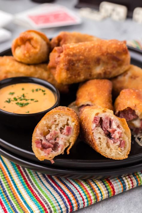 Reuben egg rolls are a must-have party appetizer with melty Swiss cheese snuggly bundled with sauerkraut and corned beef inside an egg roll wrapper. Deep fry until golden, dunk in thousand island dressing, and devour! Reuben Egg Rolls, Egg Rolls Baked, Egg Roll Wrapper, Wonton Wraps, Egg Roll Wraps, Russian Dressing, Thousand Island, Fermented Cabbage, Thousand Island Dressing