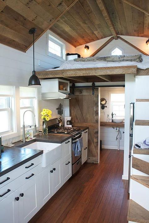 Tiny house with a custom concrete countertop, farm sink, freestanding range, and refrigerator under the storage stairs. Farmhouse Tiny House, Design Casa Piccola, Wohne Im Tiny House, Tiny House Interior Design, Best Tiny House, Tiny House Inspiration, Cozy Spaces, Tiny House Bathroom, Tiny House Kitchen