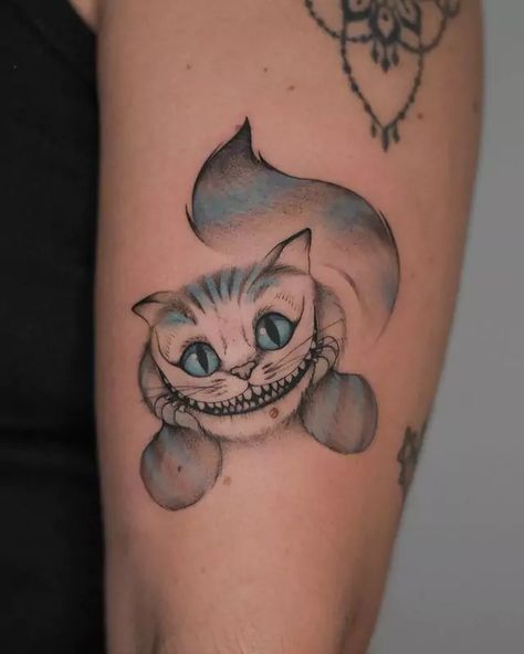 48 Stunning Cheshire Cat Tattoo Ideas You Must Try In 2024 Minimal Alice In Wonderland Tattoo, Creepy Cheshire Cat Tattoo, Mad Hatter And Cheshire Cat Tattoos, Cheshire Cat Tattoo Design, Cheshire Cat Tattoos, Crazy Cat Tattoo, Chester Cat Tattoo, Alice In Wonderland Tattoo Cheshire Cat, Alice In Wonderland Cat Tattoo