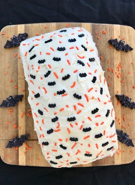 A vanilla loaf cake topped with homemade vanilla frosting and fun sprinkles is filled with a hidden surprise -- chocolate cake bats! A super fun treat for Halloween! Vanilla Loaf, Vanilla Loaf Cake, Homemade Vanilla Frosting, Bat Cake, Chocolate Whoopie Pies, Halloween Party Treats, Halloween Treats For Kids, Halloween Treats Easy, Vanilla Frosting