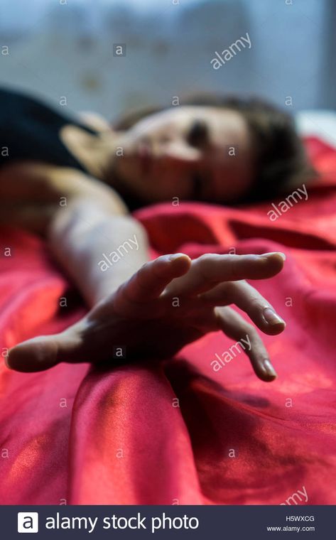 Young woman laying down in bed hand reaching out Stock Photo Hand Reaching Out Pose Reference, Crawling Out Of A Hole Reference, Laying Down Reaching Out Pose, People Reaching Out, Hand Laying Down Reference, Person Reaching Towards Camera, Laying On The Floor Reaction Pic, Person Lying Down Reference Side View, Hand Laying Flat Reference