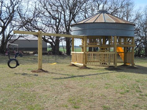 We added a "tire horse" and two swings to one side. Grain Bin Playhouse, Silo Patio, Silo Playhouse, Silo Ideas, Bin Gazebo, Grain Bin House, Grain Bins, Corn Crib, Silo House