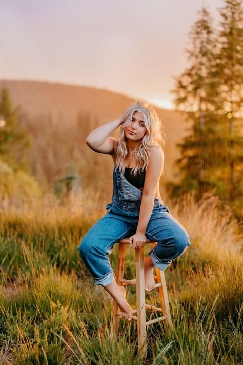 Senior Pictures With Overalls, Stool Picture Poses, Field Chair Photoshoot, Senior Picture Ideas Stool, Senior Picture Chair Poses, Non Traditional Senior Picture Ideas, Stool In Field Photoshoot, Senior Field Photos, Senior Photos In Field