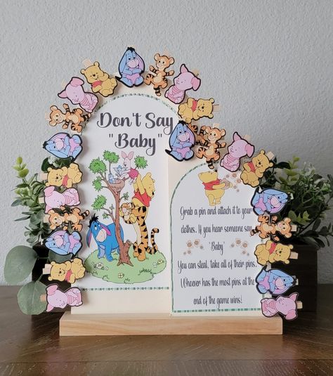 "Don't Say Baby" Winnie the Pooh & Friends mini clothe pins holder. (Characters are sold separately). You may also use plain mini cloth pins without the Character's. * Wood boards with stand * Fits up to 24 Mini clothe pins with the Characters. 30 mix Characters with plain cloth pins and 60 plain mini cloth pins. * Can be personalized upon request by messaging * Measurements: 10x15x12.2in * Print is black ink Note: The wording in the board will be as seen on the picture. Unless personalization h Baby Disney Baby Shower Ideas, Baby Pooh Baby Shower Ideas, Winnie The Pooh Baby Shower Decor, Winnie The Pooh Baby Shower Decorations, Winnie The Pooh Baby Shower Ideas Decoration, Winnie The Pooh Baby Shower Centerpieces, Winnie The Pooh Centerpiece Ideas, Pooh Bear Baby Shower Ideas, Vintage Winnie The Pooh Nursery