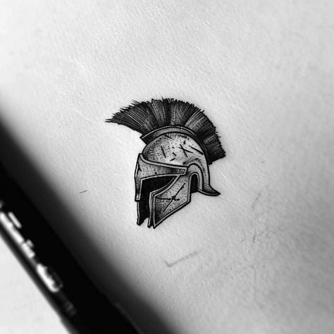 Dive into the legacy of courage and honor with this stunning Mandalorian helmet tattoo design. Embrace the warrior within and be inspired by the galaxy far, far away. Save this timeless piece and follow for more galactic wonders. Capturing the essence of resilience, this artwork symbolizes the journey of a lone warrior, carved in intricate shades of black and gray. Perfect for those who carry the spirit of adventure in their hearts. #MandalorianTattoo #StarWarsArt #Galactic Lone Warrior Tattoo, Mandalorian Helmet Tattoo, Warrior Helmet Tattoo, Helmet Tattoo Design, Achilles Helmet, Black And Gray Tattoo Design, Mandalorian Tattoo, Lone Warrior, Helmet Tattoo