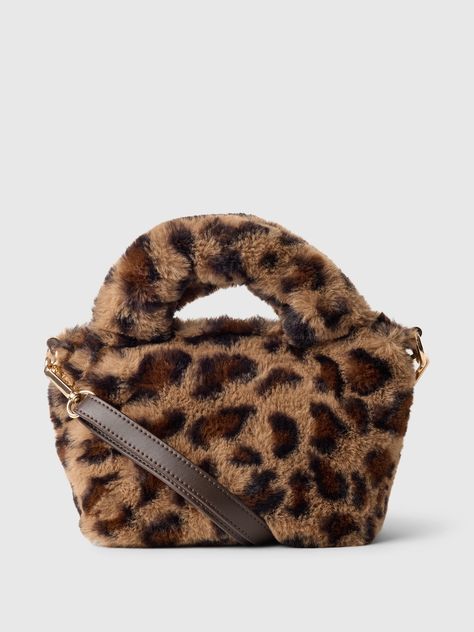 This bag is made with a faux fur upper.  Double handle and adjustable shoulder strap at top.  Snap button closure.  Fully lined.  Allover leopard print.  Dimensions: 6"H x 4" W x 6. 5" L Leopard Print Handbags, Perfect Purse, Brand Collaboration, Gap Kids, Hand Bags, Fall Wardrobe, Toddler Gifts, Cute Casual Outfits, Girls Accessories