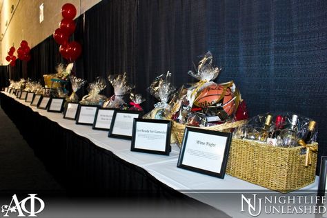 Nice basket table. Concise. Could use a pop of interest but like how easy to see descriptions and not cluttered.  Gamma Phi Auction Table. Love the frames to display the item descriptions. Fundraising Table Decorating Ideas, Auction Party Ideas, Auction Table Display Ideas, Silent Auction Table Display, Fundraiser Table Ideas, Silent Auction Set Up Display, Raffle Display Ideas, Silent Auction Set Up, Raffle Table Ideas