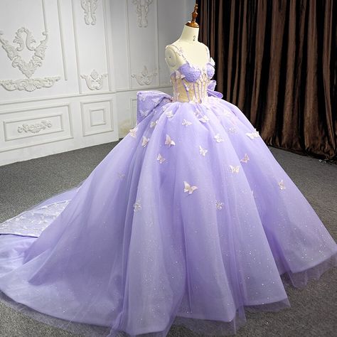 You will shine in this exquisite 3D butterfly-embellished soft lilac corset-style ball gown, boasting a sweetheart neckline and spaghetti straps, a fitted natural waist, and a glitter tulle skirt adorned with hand-embroidered butterflies. An oversized bow adorns the rear, cascading into an ethereal train with a long sash and adjustable, lace-up closure. material: glitter tulle, lace, 3d design elements color: as shown type: party ball gown corset bodice sweetheart neckline spaghetti straps lace Butterfly Quince Dress, Organza Corset, Sleeveless Ball Gown, Flower Party Dress, Purple Quinceanera Dresses, Embroidered Butterflies, Pretty Quinceanera Dresses, Dress With Corset, Quince Dress