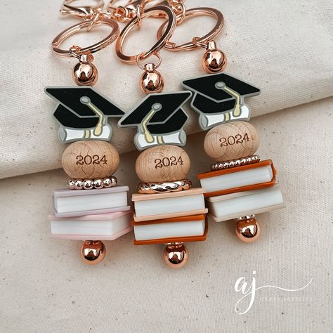 Aren’t these keyrings just perfect for 2024 graduates? 🎓 Our engraved beech wood beads, launching tonight, are a beautiful way to commemorate any special moment or milestone this year. Whether it’s a milestone birthday, moving into a new home, graduating from a course, or becoming a new mum, grandma, or aunt—the possibilities are endless. These 2024 engraved beads will be available in four different sizes tonight. ❤️ #australiansupplier #siliconebeads #personalisedkeyring #siliconebeadsaust... Graduation Hat, Beaded Christmas Ornaments, Beaded Lanyards, Beaded Crafts, Milestone Birthday, Milestone Birthdays, Silicone Beads, Focal Bead, Handmade Design