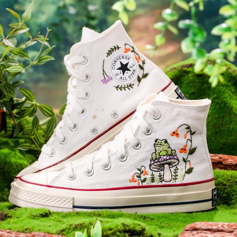 White Converse Embroidered Mushroom and Frog, Converse Chuck Taylor Embroidered Mushroom, Mushrooms Embroidered Sneakers, Mushroom Embroidery Sneakers 💚 Immerse yourself in the intricate craftsmanship as we lovingly hand embroider rustic flowers onto your chosen Converse pair 💚 🌿 The listed price encompasses both the Converse Shoes and the showcased Embroidery Designs. 1. MANUFACTURING PROCEDURE 🌿 Upon receiving your order, we initiate the shoe preparation process. If your chosen shoes are r Converse Mushroom, Embroidery Converse, Embroidery Sneakers, Converse Chuck 70s, Converse Embroidery, Mushroom Embroidery, Mushroom Frog, Embroidered Sneakers, Embroidered Converse