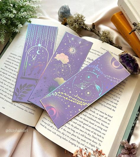 Dizzyhazel on Instagram: “Currently working on a shop update (happening this weekend)!and I’m so excited for all the new stuff that is coming to the shop! I will…” Book Mark Size, Gold Foil Bookmarks, Bookmark Packaging Ideas, Celestial Bookmarks, Lavender Packaging, Foil Bookmark, Bookmark Packaging, Bookmark Inspiration, Pretty Bookmarks