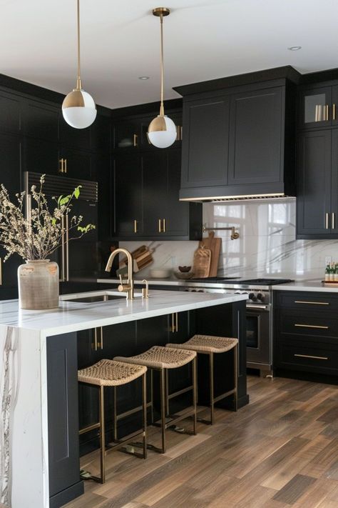 Kitchens with black cabinets exude a bold and modern aesthetic, adding a sleek and sophisticated touch to any space. The dark cabinetry creates a striking contrast against light countertops and backsplashes, making for a stunning and dramatic design statement. Modern Kitchen With Black Cabinets, Dark Kitchen With Gold Hardware, Dark Cabinets Kitchen White Countertops, Dark Kitchen Cabinets Light Countertop, Two Toned Black Kitchen Cabinets, Bold Modern Kitchen, Modern Kitchen For Small Spaces, White Oak Floors Black Cabinets, Black Cabinets White Countertops Kitchen