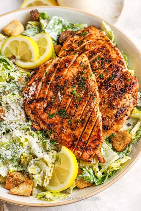 Summer wouldn't be the same without a grilled chicken Caesar salad on the menu. Make a salad at home that is better than one served at Mcdonald’s, Applebees, Wendy's, and even Paneras. This classic recipe has all the simple ingredients to make it a success - a creamy dressing, crispy croutons, and green romaine lettuce. #grilledchickencaesarsalad #chickencaesarsalad #caesarsaladwithchicken #spendwithpennies Chicken Ceaser Salad Recipe, Grilled Ceasar Salad, Healthy Caesar Salad, Grilled Chicken Caesar, Crispy Chicken Salads, Salad At Home, Grilled Romaine Salad, Chicken Caesar Salad Recipe, Grilled Chicken Recipes Easy