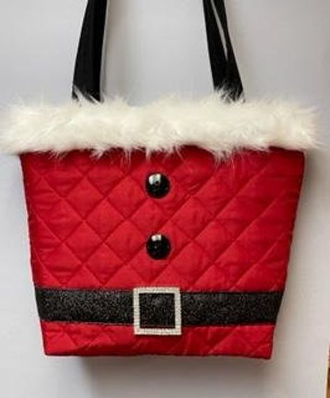 "Red quilted Santa Purse with a black velvet ribbon, rhinestone button, 2 buttons and white fur trim at top.  2 black fabric handles are lined with belting for durability. Coordinating inside fabric and contains 3 pockets and a magnetic snap 12.5\"tall, 11.5\" wide and 3.5\" bottom" Quilted Santa, Christmas Purse, Santa Bags, Purse Crafts, Sewing To Sell, Christmas Tote Bags, Christmas Tote, Tote Bags Sewing, Red Quilts