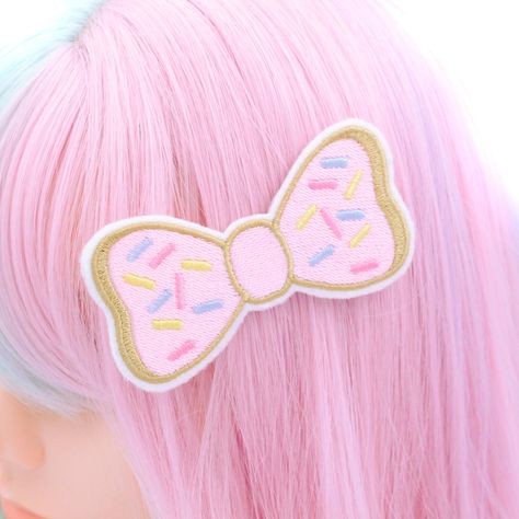 Indulge your sweet tooth with our Super Cute Doughnut Bow Hair Clip! This adorable hair clip features a doughnut-shaped bow adorned with pink icing and colorful sprinkles, all meticulously embroidered using the highest quality threads. Each detail is hand-drawn and digitized by me, ensuring a delightful and mouth-watering accessory. Handmade with love in the USA, this doughnut bow hair clip is perfect for pastry lovers and those who appreciate whimsical accessories. Whether you're grabbing coffee with friends, attending a brunch, or just want to add a touch of sweetness to your outfit, this hair clip is sure to make you smile. Complete with a metal hair clip sewn to the back, this doughnut bow clip is easy to attach and secure in place. Elevate your style with this handmade accessory, lovi Pink Kidcore Aesthetic, Cute Doughnut, Candy Accessories, Donut Hair, Whimsical Accessories, Sweet Like Candy, Kawaii Clothing, Pink Icing, Kawaii Hairstyles