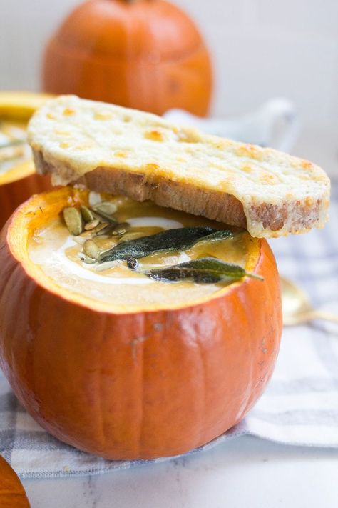 Creamy Pumpkin Soup, served in a pumpkin, is a spicy, creamy and delicious homemade pumpkin soup topped with fried sage, pepitas and cheesy toast for dipping. This will be your new favorite fall soup recipe! Fried Sage, Creamy Pumpkin Soup, Pumpkin Bowls, Fall Soup Recipes, Roasted Pumpkin, Roasted Pumpkin Seeds, Fall Soups, Roast Pumpkin, Homemade Pumpkin