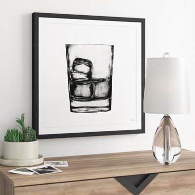 On the rocks. This wall art brings a contemporary feel to your kitchen or home bar with a modern and minimalist depiction of a classic order. Originally a sketch by artist Eyre Tarney, it's a reproduction printed with premium, crisp black-and-white inks on artist-grade paper. The square design features a glass of bourbon over ice against a clean white background. We love that the neutral hues of this understated modern wall art go with nearly any color palette. Mounting hardware included. Size: Modern Bar Art, Artwork For Guys Apartment, Whiskey Room Art, Art For Bar Area, Bar Wall Art Ideas, Men’s Wall Decor, Bar Artwork Decor, Glass Of Bourbon, Home Bar Wall Decor