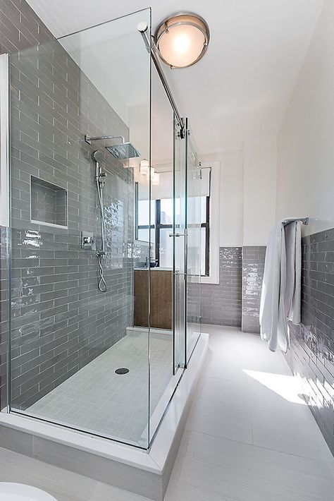 NYC bathroom remodel in Midtown West in gray and white. Gray subway tile in the shower and along the walls make this feel luxurious. Glass shower enclosure. Upgraded fixtures and lighting complete the look. See the full project gallery at https://www.myhomeus.com/project-gallery/midtown-west/321-west-55th-street-2/ Small Bathroom Trends, Pearl House, Harlem Nyc, Simple Kitchen Remodel, Chord Progressions, Contemporary Bathroom Designs, Bathroom Red, Kitchen Bathroom Remodel, Apartment Renovation