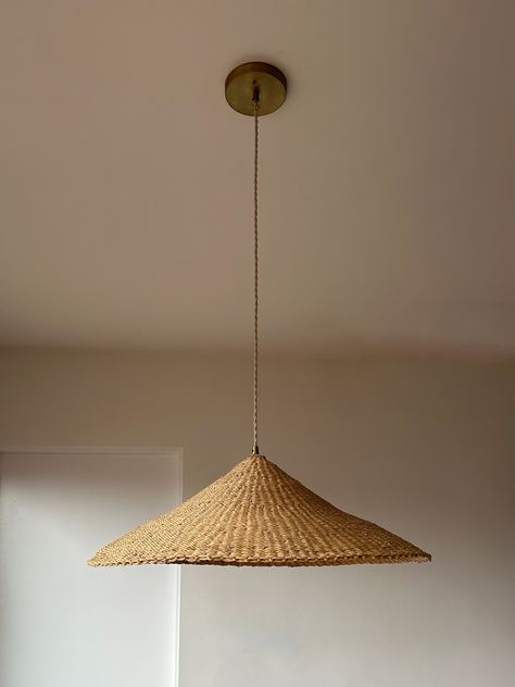 Our Sunhat pendant light is one of our most popular woven light fixtures. Handcrafted in a shallow cone shape from richly textured indigenous and sustainable elephant grass, this woven light shade is made by members of SWOPA, a women's organization for traditional arts in northern Ghana. Each natural grass lampshade is woven by hand and each is slightly uniquely different. Emitting a warm glow these woven pendant lights are ideal for any living space. SHADE DIMENSIONS* Size Height Diameter MEDIU Dining Pendant Light, Large Pendant Lighting, House On The Rock, Kitchen Pendants, Handmade Lighting, Brass Fittings, Pink Room, Lighting Inspiration, Room Wallpaper