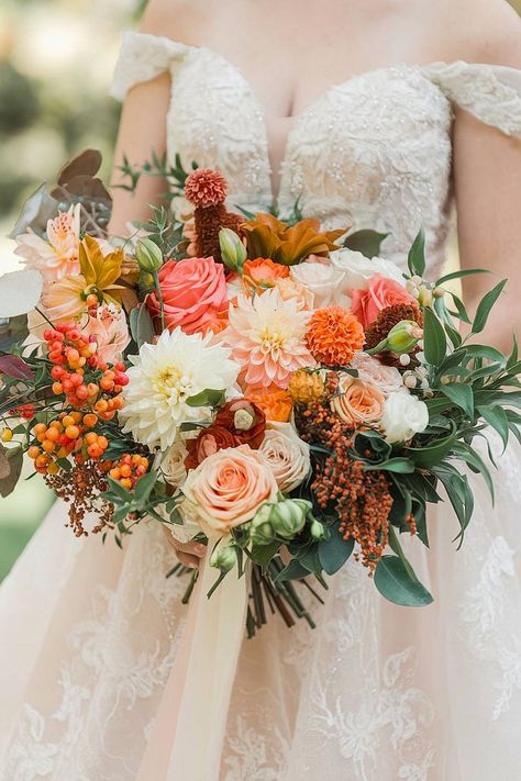 A fall bridal bouquet with dahlias, roses, and orange berries. Fall Colored Wedding Bouquet, Bridal Bouquet Garden Style, Peach Dahlia Bouquet, Colorful Fall Bouquet, Marigold Wedding Bouquet, Fall Wedding Bouquets October, Fall Wedding Flower Arrangements, Fall Bouquet Wedding, Summer Flowers Wedding