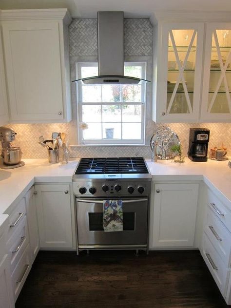 professional kitchenaid gas cooktop with convection oven. oven in front of window. stainless vent in front of window. LED vent hood with arabescato herringbone pattern backspash. white shaker cabinets. white thick slab quartz countertops. LG brand. Empire collection hardware. Kitchen Vent, Kitchen Hoods, Kitchen Stove, Trendy Kitchen, Kitchen Redo, Kitchen Window, Updated Kitchen, Kitchen Remodel Idea, White Cabinets